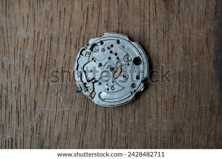 close up of automatic watch movement on wooden background