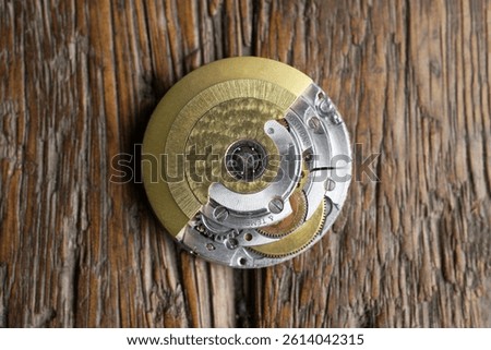 close up of automatic watch movement on wooden background                                 