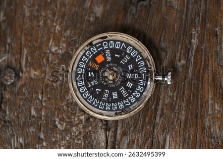 close up of automatic watch movement on wooden background                                 