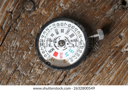 close up of automatic watch movement on wooden background                                