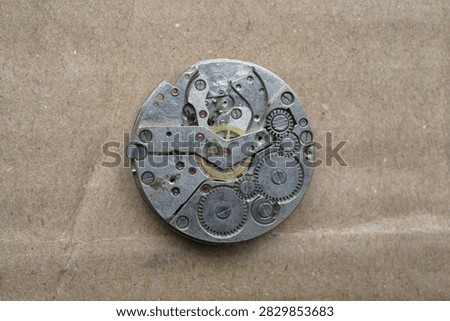 close up of automatic watch movement on cardboard background                               