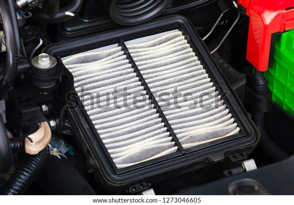 close up\
of automobile car engine air filter in cage\
