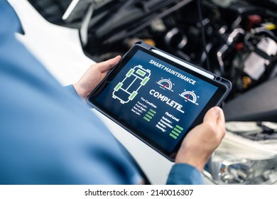 Close Up Of Automotive Mechanic Running Diagnostics Software On Tablet. Asian Young Vehicle Service Manager Worker Work In Mechanics Garage, Check And Maintenance To Repair The Engine Car In Workshop.