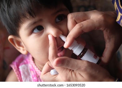 Close Up Of Baby Child Taking Medicine On Nose 