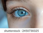 Close up baby girl eye photo. Caucasian kid child girl eye macro nature beauty blue color iris and brown hair. Look to the camera close view portrait photo.