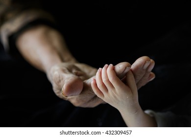 Close up baby hands holding grandmother, New family and baby protection concept - Shutterstock ID 432309457