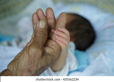 Close Up Baby Hands Holding Grandmother (Soft Focus And Blurry)