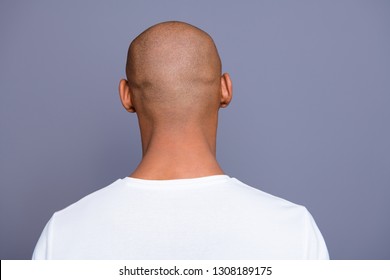 Close Up Back Behind Rear View Photo Dark Skin He Him His Man Turned To Empty Space Distracted Unrecognizable Groomed Shaved Head Wearing White T-shirt Outfit Clothes Isolated On Grey Background