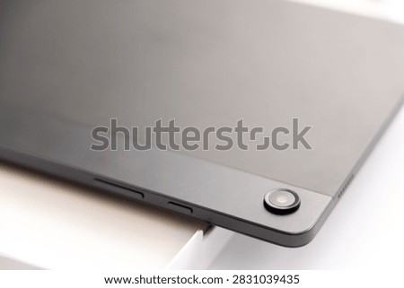 A close up of the back camera of a tablet