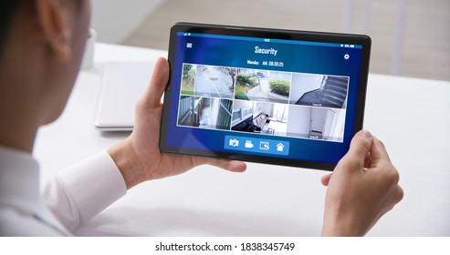 Close Up Of Back View Asian Businessman Rear View Using Home Security Camera System On Tablet Pc In The Office