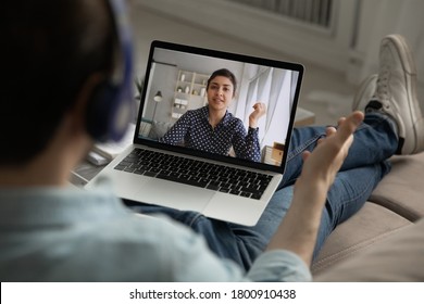 Close up back view of man have webcam online meeting or virtual conversation with female colleague or client, male speak talk on video call on laptop with ethnic woman, digital conference concept - Shutterstock ID 1800910438