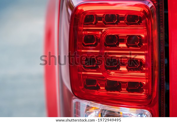 Close up Back\
view red tail lights of red\
pick-up