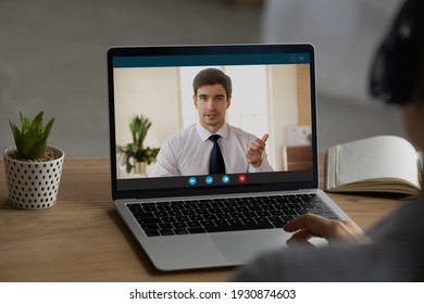 Close Up Back View Of Woman Sit At Desk At Home Office Have Webcam Online Virtual Conference With Boss Or CEO. Female Employee Talk Speak On Video Call On Computer With Client. Technology Concept.