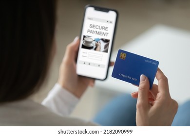 Close Up Back View Of Woman Use Modern Cellphone Gadget Make Secure Online Payment With Credit Card. Female Client Buyer Pay Shop On Internet On Smartphone, Use Bank Service System Or Application.