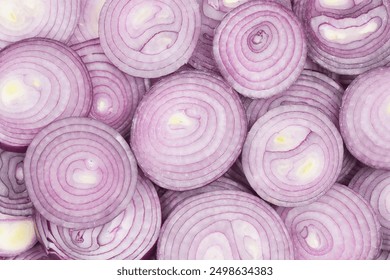 Close up background photograph of raw red onions rings slices arranged together. Food cooking ingredient. Healthy eating concept. Nutrition and diet. Antibacterial. Heart health. Top view. 