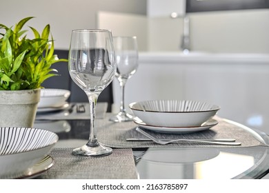 Close Up Background Of Table Settings For Dinner, Arrangement With Empty Wine Glasses, Plates On Place Mat On Glass Dining Table, No People. Food And Drinks, Kitchenware, Dinnerware Store Ad Concept