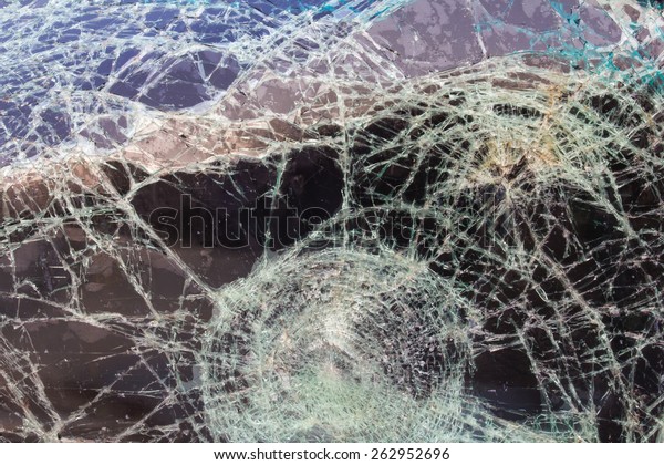 Close up background texture of cracked\
windshield damage from car\
accidents.