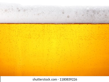 Close Up Background Texture Of Lager Beer With Bubbles And Froth In Glass, Low Angle Side View