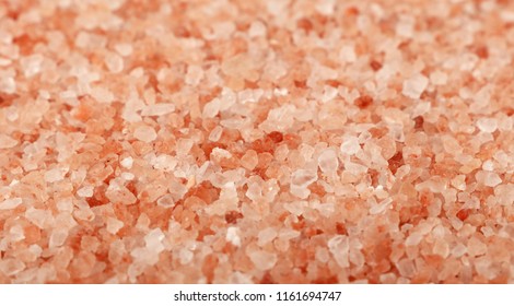 Close up background texture of large and medium crystals pink Himalayan salt, high angle view, selective focus