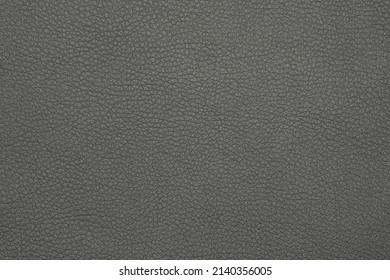 Close up background texture pattern of black natural leather grain, directly above