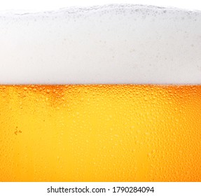 Close Up Background Texture Of Pouring Lager Beer With Bubbles And Froth In Frosty Glass With Drops, Low Angle Side View