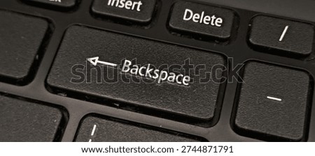 Close up of the backspace key on a keyboard. Macro shot of the backspace button on a black laptop keyboard. Symbol of correction, deleting errors and editing text