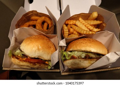 Close up Bacon cheese burger with onion rings and crinkle cut fries - Powered by Shutterstock