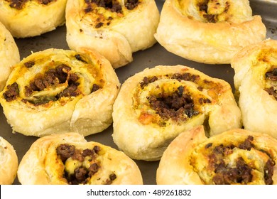 Close Up Of Baking Rack With Fresh Baked Homemade Beef Pumpkin Pinwheels.