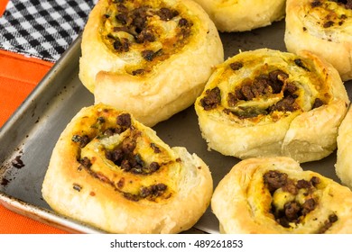 Close Up Of Baking Rack With Fresh Baked Homemade Beef Pumpkin Pinwheels.