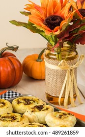 Close Up Of Baking Rack With Fresh Baked Homemade Beef Pumpkin Pinwheels.