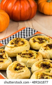 Close Up Of Baking Rack With Fresh Baked Homemade Beef Pumpkin Pinwheels.