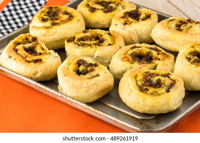 Close Up Of Baking Rack With Fresh Baked Homemade Beef Pumpkin Pinwheels.