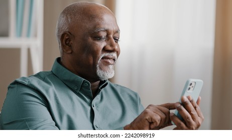 Close up bald American bearded old senior man with gray beard elderly male using software application net on cellphone reading message email swiping browsing online app. smartphone Wi-Fi technology - Powered by Shutterstock