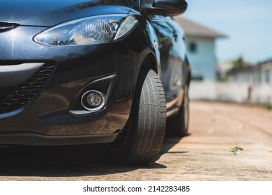 Close up bald front wheel tire. Car maintenance and service concept. - Shutterstock ID 2142283485