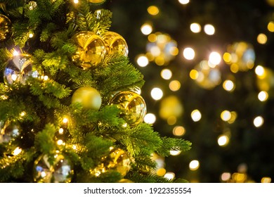 Close Up Of Balls On Christmas Tree. Bokeh Garlands In The Background Golden Light Holidays Concepy