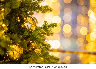 Close Up Of Balls On Christmas Tree. Bokeh Garlands In The Background Golden Light Holidays Concepy