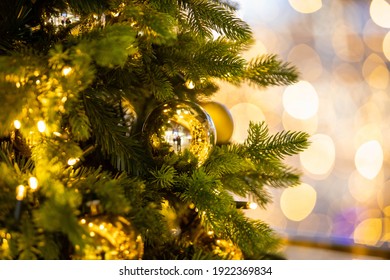 Close Up Of Balls On Christmas Tree. Bokeh Garlands In The Background Golden Light Holidays Concepy