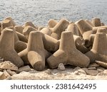 close up of a bank of coastal sea defence concrete blocks interlinked on the beach