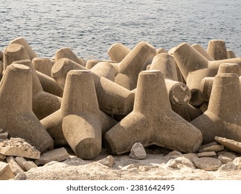close up of a bank of coastal sea defence concrete blocks interlinked on the beach