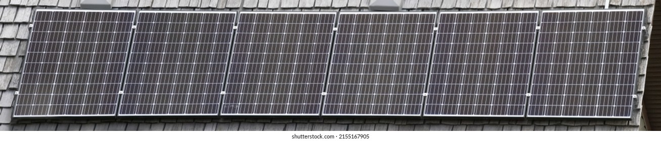 A Close Up Banner Of Solar Panel Cells On A House Roof.