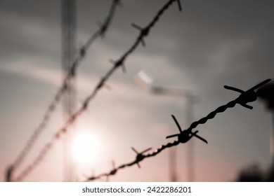 Close up of barbed wire against the sky  - Powered by Shutterstock