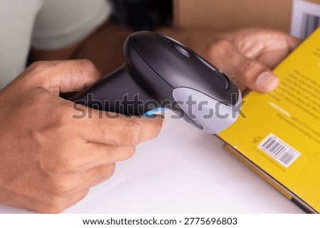 Close up barcode scanner scanning the book, Inspecting books in 