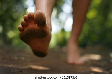Close Up Of Bare Feet Running On A Trail In The Forest.  