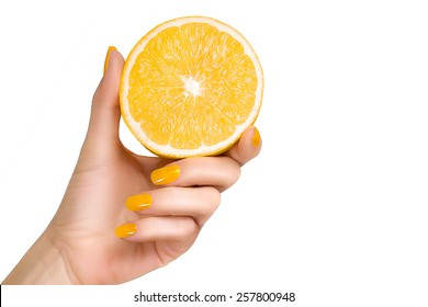 Close Up Bare Hand With Yellow Nails Holding A Sliced Fresh Lemon Fruit. Isolated On A White Background With Copy Space For Text.