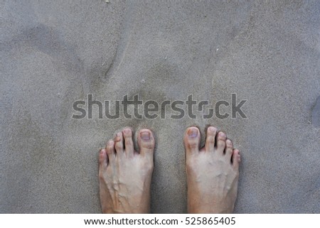 Close up barefoot female on sand on the beach and copy space on top of picture