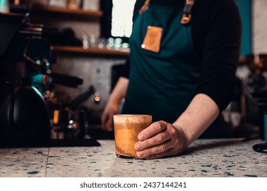 Close up of barista hand holding glass cup with coffee. - Powered by Shutterstock