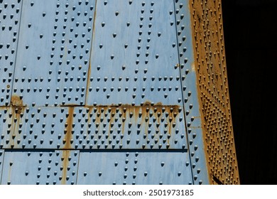 Close up of the base of the Manhattan Bridge highlighting the pattern of rivets in the blue steel - Powered by Shutterstock