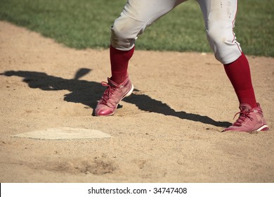 Close Up Of Baseball Batter's Legs At Home Plate