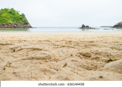 Close Up Beach Sand With Blur Sea At Background,low Angle View.