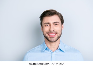 Close up of beaming smile bearded man looking at camera while standing over grey background, he is so stylish